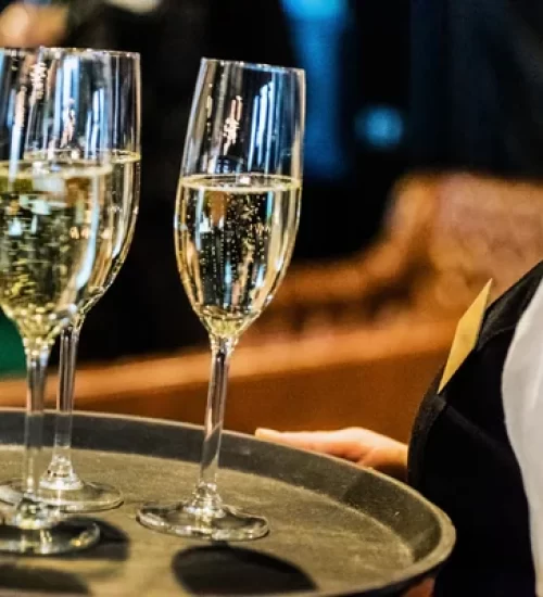 depositphotos_104905030-stock-photo-waiter-with-champagne-glasses